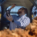 Man Checking Emergency Switch in Skid Steer