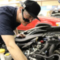 Auto Technician Working on Vehicle Engine